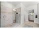 Walk-in shower featuring neutral tile, glass enclosure, and built-in shelving in this well-designed bathroom at 4137 Avid Park, Marietta, GA 30062