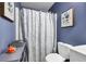 Cozy bathroom featuring blue floral shower curtain, toilet, and vanity at 5115 Estonian Dr, Fairburn, GA 30213