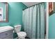 Charming teal bathroom with a combination tub and shower, a modern sink, and attractive design elements at 5115 Estonian Dr, Fairburn, GA 30213