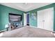 Large bedroom featuring soft carpet, a tray ceiling, a ceiling fan, and double closets at 5115 Estonian Dr, Fairburn, GA 30213