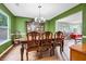 Open dining room featuring hardwood flooring and connected living room at 5115 Estonian Dr, Fairburn, GA 30213