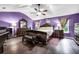 A luxurious main bedroom with hardwood floors, a ceiling fan, and elegant dark wood furniture at 5115 Estonian Dr, Fairburn, GA 30213