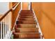 Wooden stairway, adorned with candles, leading up from the ground floor at 5115 Estonian Dr, Fairburn, GA 30213