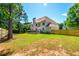 Spacious backyard with a well-manicured lawn, mature trees, and a wooden fence at 1096 Bridge Mill Ave, Canton, GA 30114