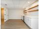 A bar area with floating shelves, stainless steel dishwasher and sink, and white cabinets at 1096 Bridge Mill Ave, Canton, GA 30114