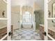 Bright bathroom with a freestanding tub, glass shower, dual vanities, and marble floors at 1096 Bridge Mill Ave, Canton, GA 30114