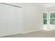 Bright bedroom with carpet floors, a closet, and large windows offering natural light at 1096 Bridge Mill Ave, Canton, GA 30114