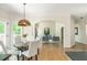 Dining area showcasing hardwood floors and an open transition to the living room with large windows at 1096 Bridge Mill Ave, Canton, GA 30114