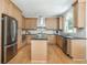 Well-lit kitchen featuring stainless steel appliances, light wood cabinets, and a functional center island at 1096 Bridge Mill Ave, Canton, GA 30114