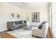 Cozy living room with neutral walls, hardwood floors, and ample natural light from the windows at 1096 Bridge Mill Ave, Canton, GA 30114