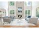 Airy living room with a soaring ceiling, a fireplace, hardwood floors, and an elegant neutral palette at 1096 Bridge Mill Ave, Canton, GA 30114