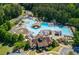 Aerial view of a community pool area with water slides, lounge chairs, and lush landscaping at 1096 Bridge Mill Ave, Canton, GA 30114