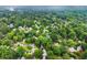 An aerial view of the neighborhood shows mature trees and winding streets at 215 Truehedge Trce, Roswell, GA 30076