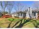 Backyard featuring a deck, grassy lawn, and mature trees, perfect for outdoor entertaining at 215 Truehedge Trce, Roswell, GA 30076