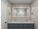 Bathroom with double sink vanity, modern lighting, and framed mirror at 215 Truehedge Trce, Roswell, GA 30076