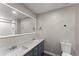 Updated bathroom featuring double sink vanity, illuminated mirror, and tiled shower at 215 Truehedge Trce, Roswell, GA 30076