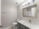 Bathroom featuring a sleek vanity with a marble countertop and modern fixtures at 215 Truehedge Trce, Roswell, GA 30076