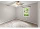 Comfortable bedroom with ceiling fan and scenic window view for relaxation at 215 Truehedge Trce, Roswell, GA 30076