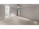 Spacious bedroom featuring neutral carpeting, ceiling fan, and adjoining bathroom at 215 Truehedge Trce, Roswell, GA 30076