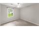Well-lit bedroom with plush carpeting and a large window at 215 Truehedge Trce, Roswell, GA 30076