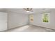 Large bedroom with plush carpeting, a ceiling fan, and windows letting in plenty of light at 215 Truehedge Trce, Roswell, GA 30076
