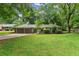 Lovely single-story home with attached garage, mature trees, and a well-maintained lawn at 215 Truehedge Trce, Roswell, GA 30076