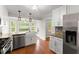 Modern kitchen with stainless steel appliances, a farmhouse sink, and granite countertops at 215 Truehedge Trce, Roswell, GA 30076