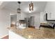 Modern kitchen with granite countertops, stainless steel appliances, and open layout at 215 Truehedge Trce, Roswell, GA 30076