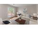 Bright living room featuring a white sofa, french doors to deck, and a patterned rug at 215 Truehedge Trce, Roswell, GA 30076