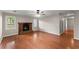 Bright living room features hardwood floors, a cozy brick fireplace, and large windows at 215 Truehedge Trce, Roswell, GA 30076