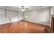 Large, bright living room features built-in cabinets, hardwood floors, and a brick fireplace at 215 Truehedge Trce, Roswell, GA 30076