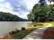 Picturesque waterfront view with a scenic walking path, lush greenery, and serene lake waters at 215 Truehedge Trce, Roswell, GA 30076