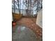Unkempt backyard with a combination of concrete, bare dirt, and leaves at 6002 Pat Mell Se Pl, Smyrna, GA 30080