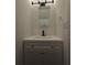 Small, clean bathroom with a new vanity, modern faucet, and updated lighting at 6002 Pat Mell Se Pl, Smyrna, GA 30080