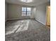 Bright bedroom features new carpet, modern light fixture, and large window offering ample natural light at 6002 Pat Mell Se Pl, Smyrna, GA 30080