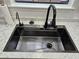 Close-up of modern kitchen sink with sleek faucet and accessories at 6002 Pat Mell Se Pl, Smyrna, GA 30080