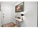 Shot of the white foyer that includes a decorative table, a floral display, and a painting at 607 Riverview Se Dr # 607, Marietta, GA 30067