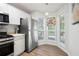 Bright kitchen featuring stainless steel appliances, white cabinetry, wood grain flooring, and stained glass at 607 Riverview Se Dr # 607, Marietta, GA 30067