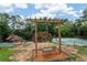Community recreation area featuring pool, tennis courts, and a relaxing swing at 607 Riverview Se Dr # 607, Marietta, GA 30067