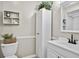 Updated bathroom features a white vanity, toilet, and linen closet with plants to add a pop of color at 663 Serramonte Dr, Marietta, GA 30068