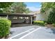Attached carport providing covered parking and easy access to the home, complemented by green shrubs at 663 Serramonte Dr, Marietta, GA 30068