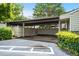 Attached carport with privacy fencing for convenient parking and outdoor storage, surrounded by lush landscaping at 663 Serramonte Dr, Marietta, GA 30068