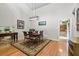Warm dining room with a round wood table, chairs, and stylish rug on hardwood floors at 663 Serramonte Dr, Marietta, GA 30068