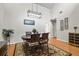 Traditional dining room featuring hardwood floors, a round table, and stylish light fixture at 663 Serramonte Dr, Marietta, GA 30068