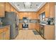 Well-lit kitchen with wood cabinets, stainless steel appliances, and plenty of counter space at 663 Serramonte Dr, Marietta, GA 30068
