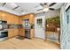 Bright kitchen featuring natural wood cabinets, stainless steel appliances, and sliding glass doors at 663 Serramonte Dr, Marietta, GA 30068