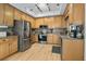 Spacious kitchen featuring wood cabinets, stainless steel appliances, and light vinyl flooring at 663 Serramonte Dr, Marietta, GA 30068