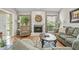 Comfortable living room with a stone fireplace, hardwood floors, and plenty of natural light at 663 Serramonte Dr, Marietta, GA 30068
