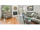 Cozy living room with a stone fireplace, comfortable seating, and hardwood floors at 663 Serramonte Dr, Marietta, GA 30068