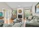 Bright living room featuring a stone fireplace, hardwood floors, and comfortable seating at 663 Serramonte Dr, Marietta, GA 30068